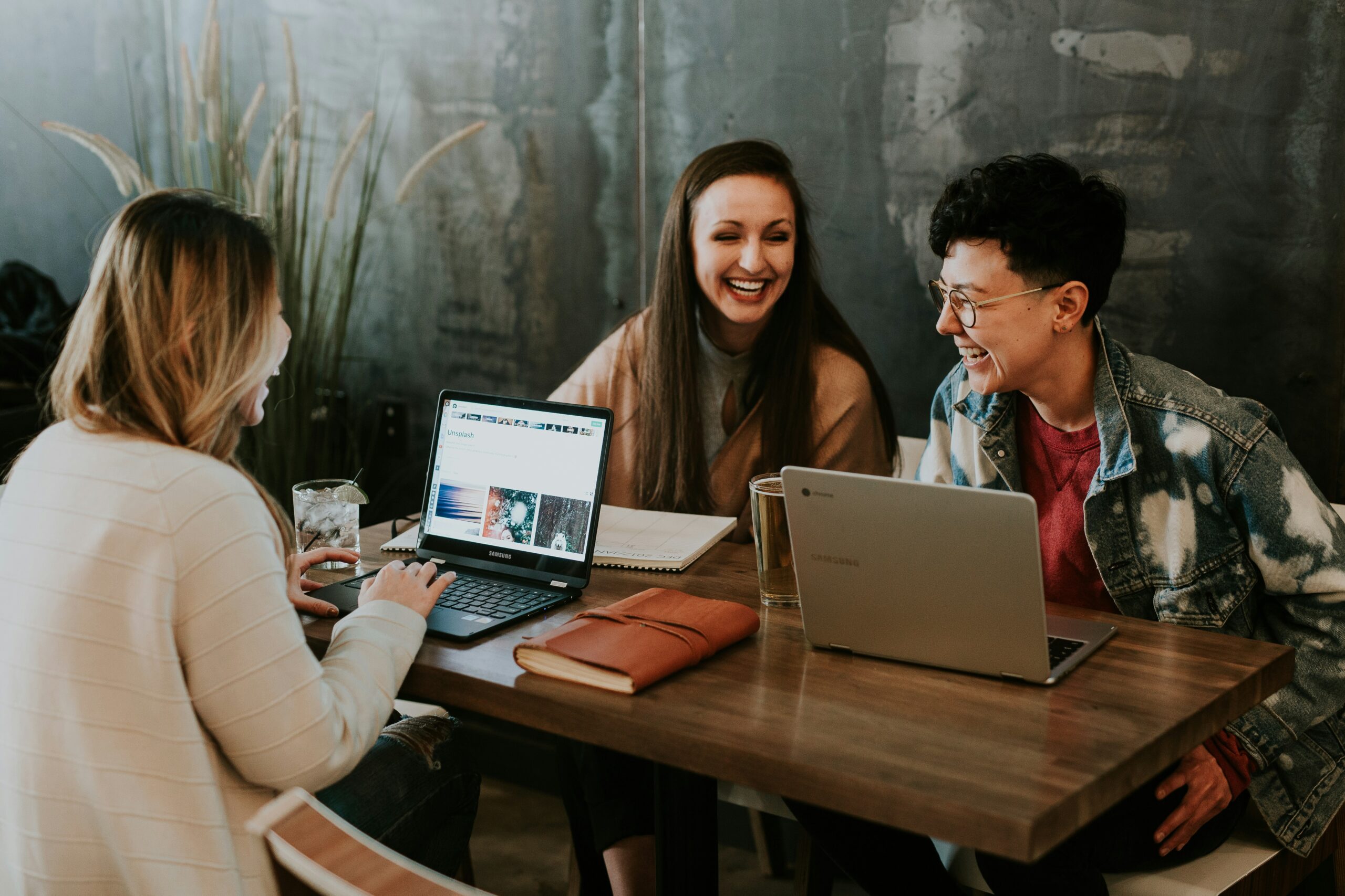 A group of marketing team members sitting at a table with laptops